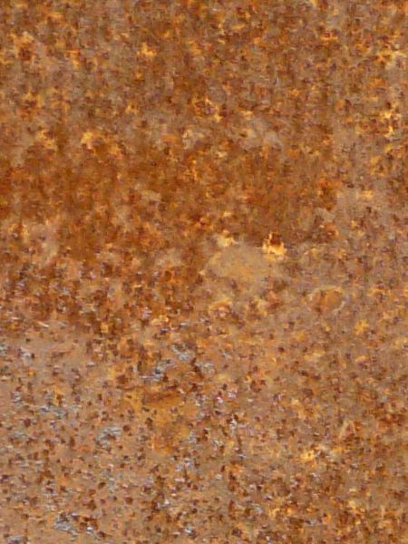 Red rust texture with various light patches and small rust specks throughout.